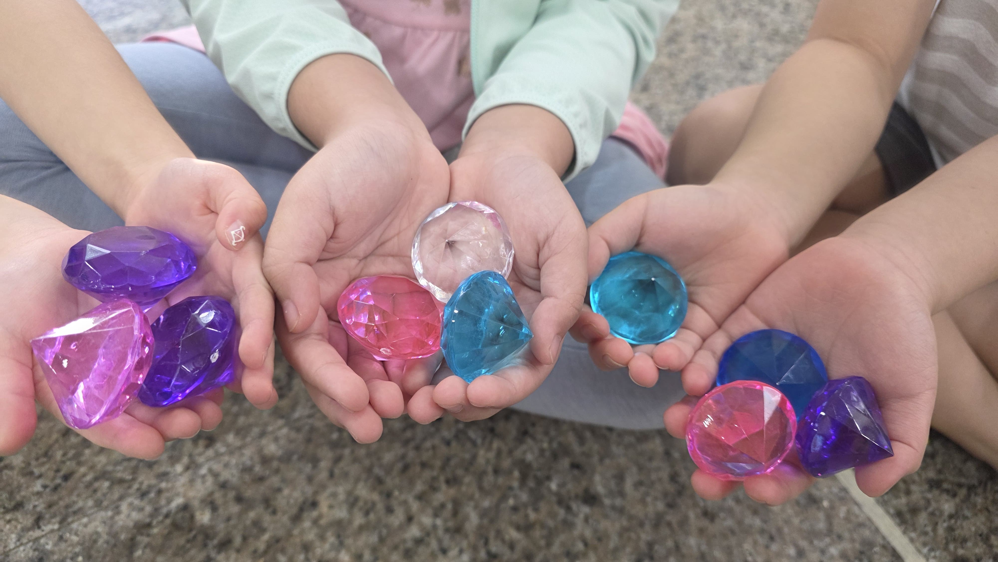 Children at Genius Gems Childcare Centre proudly holding colourful gems during character development
